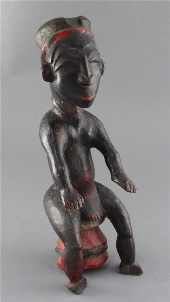 An Attye People Ivory Coast carved and painted hardwood seated shrine figure, height 38cm